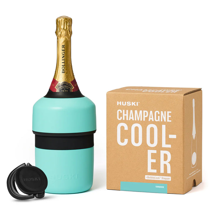 Turquoise champagne cooler with Bollinger bottle and Huski packaging on a white background