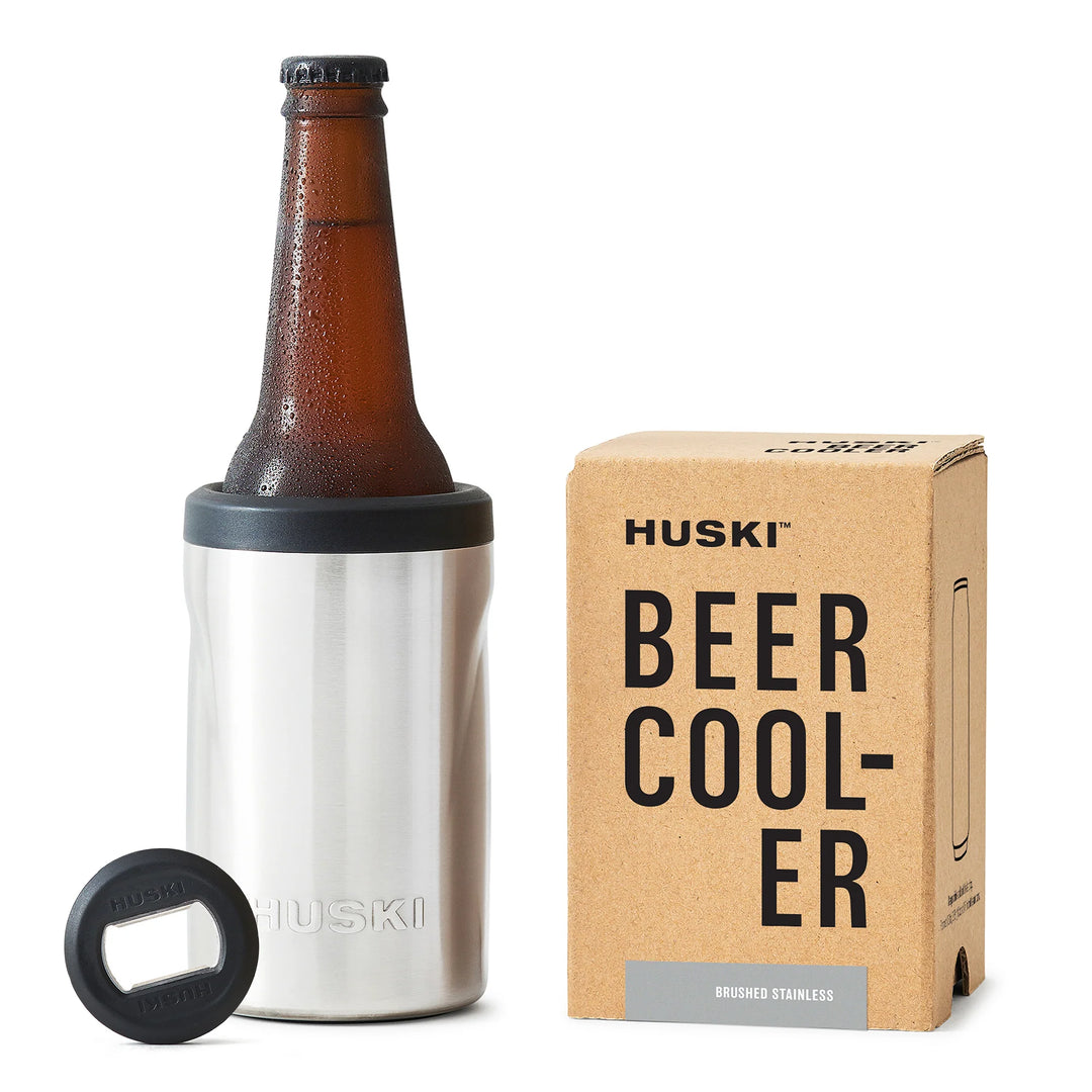 Huski Beer Cooler 2.0 in Brushed Stainless with a beer bottle inserted next to its packaging