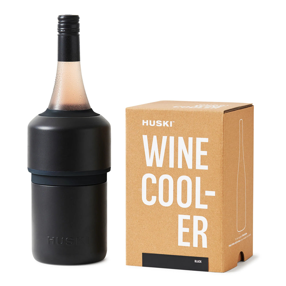 A Huski Wine Cooler in Black fitted onto a wine bottle, displayed next to its packaging box.